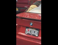 Red car orange MTA vest license plate 