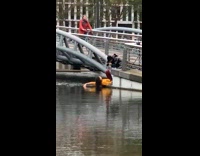 Woman yellow top lay down stairs river