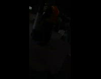 Guy wearing safety vest dances in warehouse 