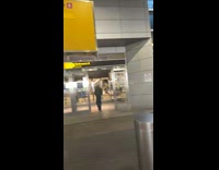 2 people in T-rex costumes wait at airport 