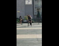 Girl dances choreography busy area people walking 