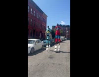Collab winy - Men wearing stilts walking on street 