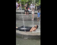 Same guy wearing wetsuit on fountain