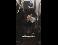 Man holds skull of sabertooth tiger on subway train