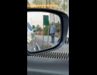 Man smokes near hospital no smoking sign