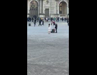 Lady Stands Still as Man Takes Pictures