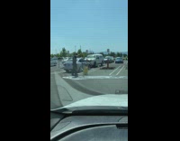 Guy mops parking lot ground yellow bucket