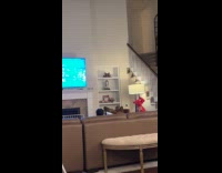 Dad controls baby swim dancing on couch