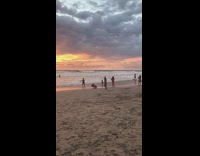 Two girls in bikini jump shot on the beach
