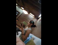 Woman with coconut ice cream at restaurant