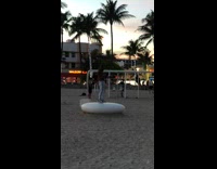 Shirtless guy takes selfie at beach