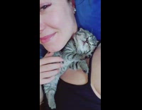 Cat sleeping on neck of woman 