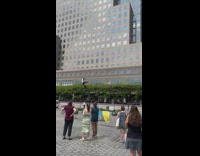 People on tall sticks bend back and forth 