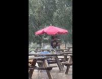 Collab WINY - Man takes cover from storm while eating