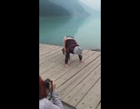 girl back flips on lake dock face plant