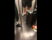 Man wears Gucci slipper sandals with ballerina socks on subway train