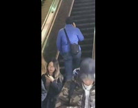 Man blue jacket walks up wrong opposite side of escalators 