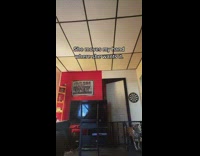 Guy white shirt curly big hair falls over