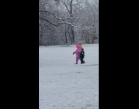Woman walking in park with guy in unicorn costume 