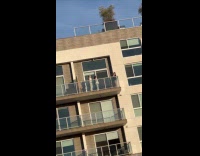 Two women white top balcony dance video