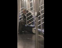 Old man smokes at the end on subway train