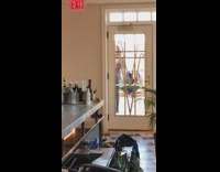 Woman in leather pants models with a handbag