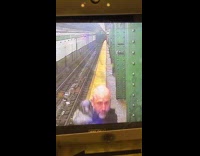 Man dance on subway platform at camera