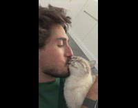 Guy keeps kissing face of his cat