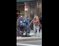 Shirtless man does push up on street