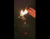 Person grab torch flame slow motion night