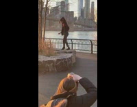 man brown jacket dancing nyc bridge