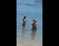 Woman red bikini wet shoulder photo shoot beach