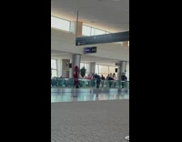 Guy in red poses on airport belt 