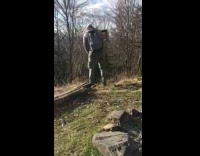 Guy peeing on a hike loses balance and falls forward