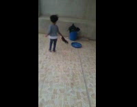 Little girl spins cat from its tail