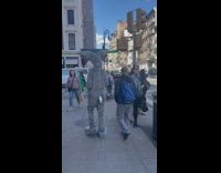 Guy in rabbit suit walking on the street 
