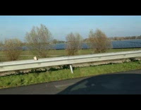 Girl drives by solar panels on ground 