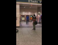 Guy with TV set on his head records man singing and playing guitar with his camera