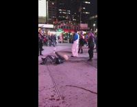 Man white overalls blue shirt covered in blood and drips on the sidewalk