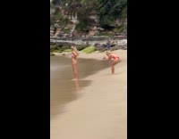 Two women beach bikini photoshoot near family
