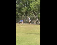 Man in white shirt plays golf with video shoot