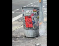 Trash bin at pedestrian crossing on fire