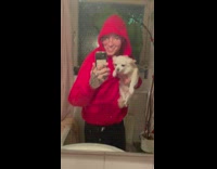 Man in red jacket with dog dance in the bathroom