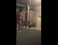 guy in red and white underwear spins on pole