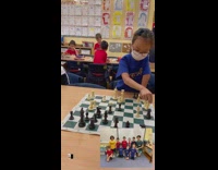 Kids play chess in classroom 