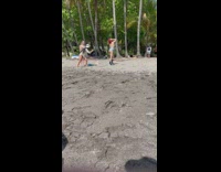 Woman in blue bikini poses at the beach