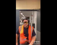 Collab BS Media - Guy in orange vest swings hockey stick, tackles trash can, twerks on cart