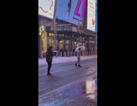 Shirtless guy holds umbrella while it snows 