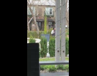 Woman brim hat takes picture with fountain