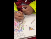 Guy rides subway draws lines on sketchpad